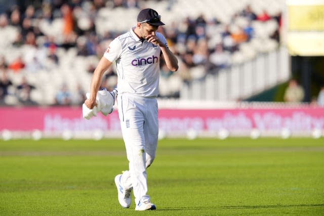 A dejected Mark Wood walks off the Old Trafford pitch after picking up an injury