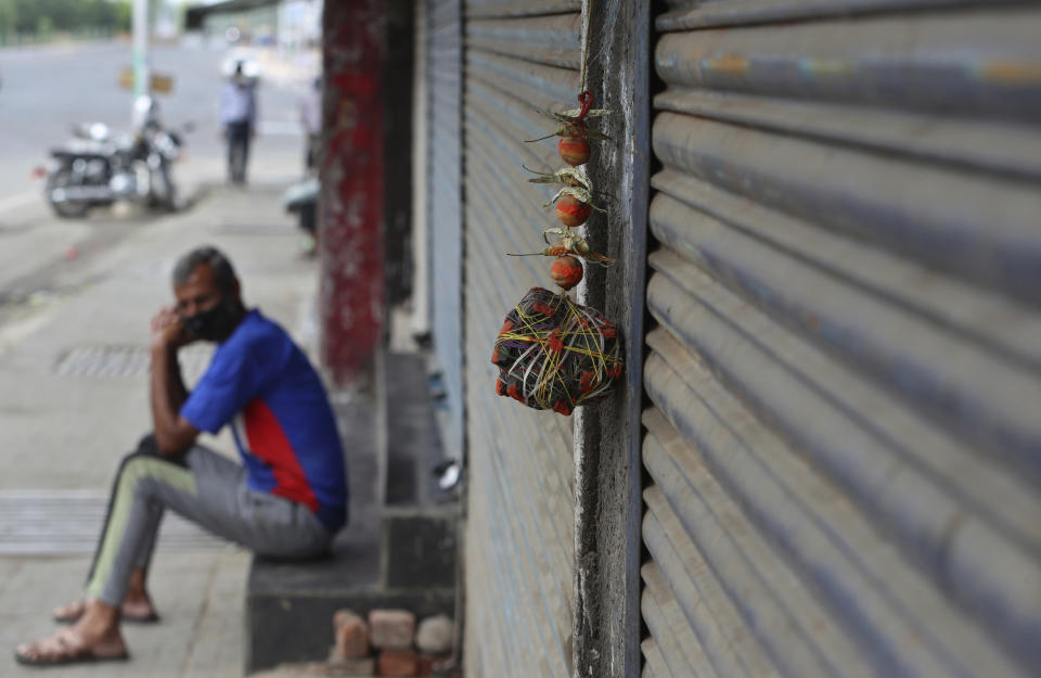 Lemon and chillies, believed to ward away the evil are hung outside a closed shop during restrictions to curb the spread of coronavirus in Jammu, India, Wednesday, May 12, 2021. Misinformation about the coronavirus is surging in India as the death toll from COVID-19 rises. Fueled by anguish, distrust and political polarization, the claims are further compounding India's crisis. (AP Photo/Channi Anand)