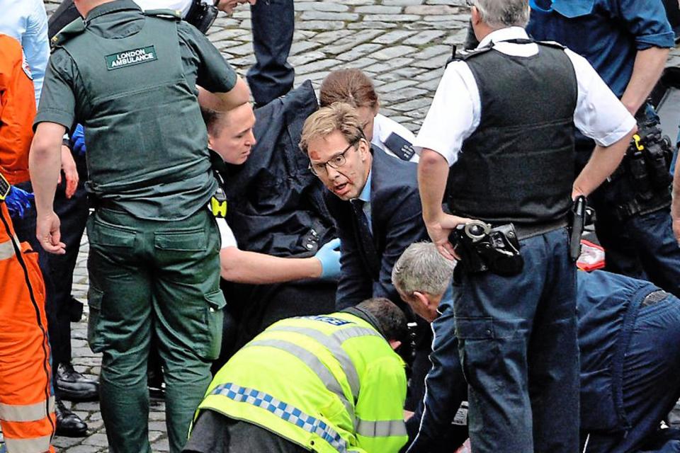 Caught up in the attack: Tobias Ellwood MP tries to save PC Keith Palmer outside the Palace of Westminster: Stefan Rousseau/PA Wire