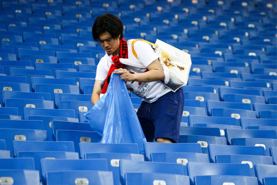 Japanese fans clean trash after devastating loss