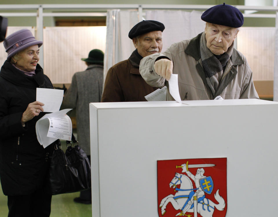 A Lithuanian voter casts his ballot at a polling station in Vilnius, Lithuania, Sunday, Oct. 14, 2012. Lithuanians are expected to deal a double-blow to the incumbent conservative government in national elections Sunday by handing a victory to opposition leftists and populists and saying 'no' to a new nuclear power plant that supporters claim would boost the country's energy independence. (AP Photo/Mindaugas Kulbis)