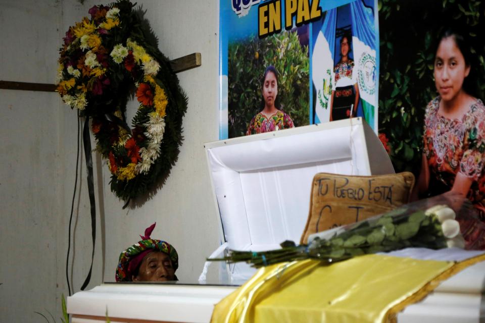 A woman prays next to the coffin of Claudia Gomez, a Guatemalan immigrant who was shot by a U.S. Border Patrol officer, during her wake at her home in Guatemala on June 1, 2018.