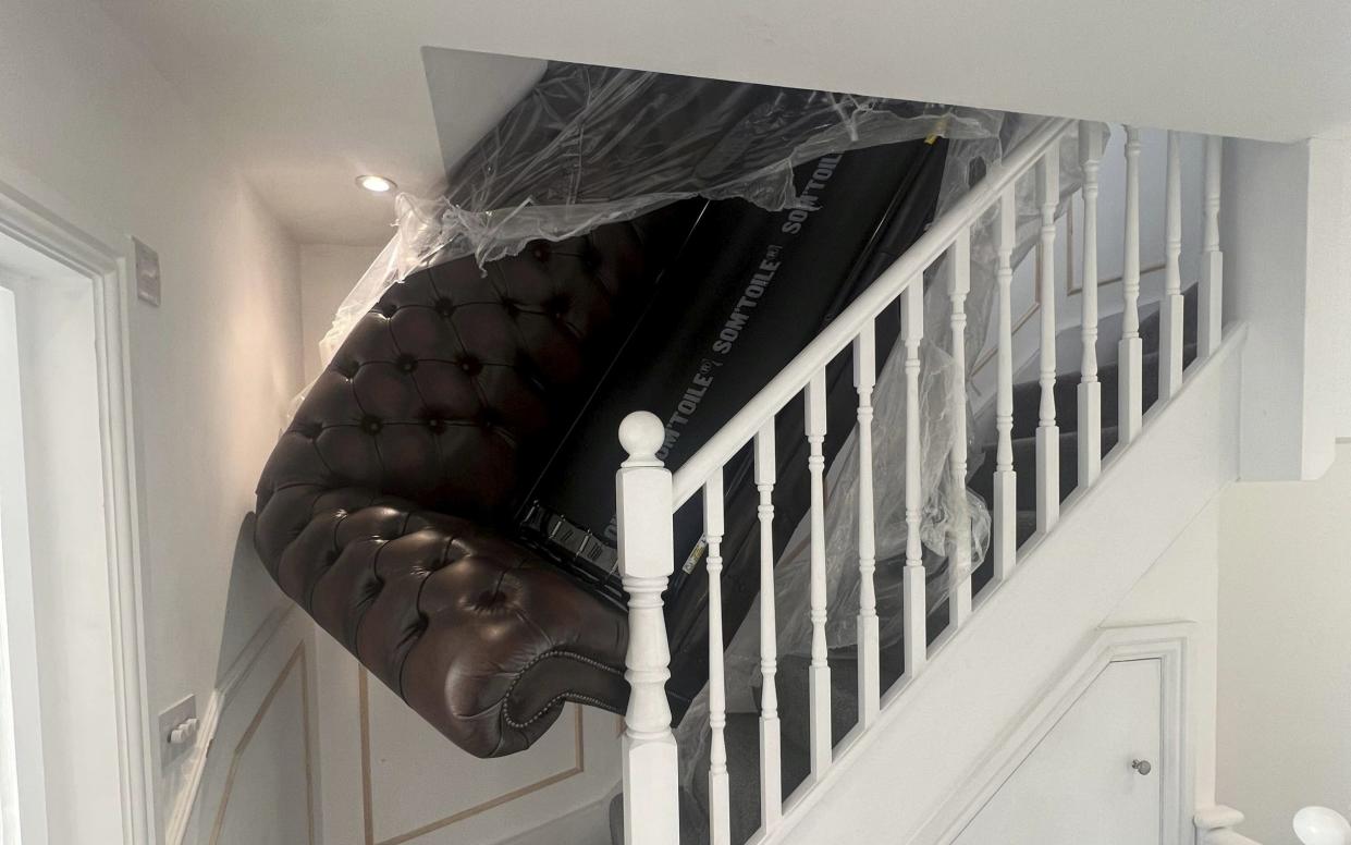 Mr Ansell posted a photo of the sofa wedged in his staircase on social media - SWNS/SWNS