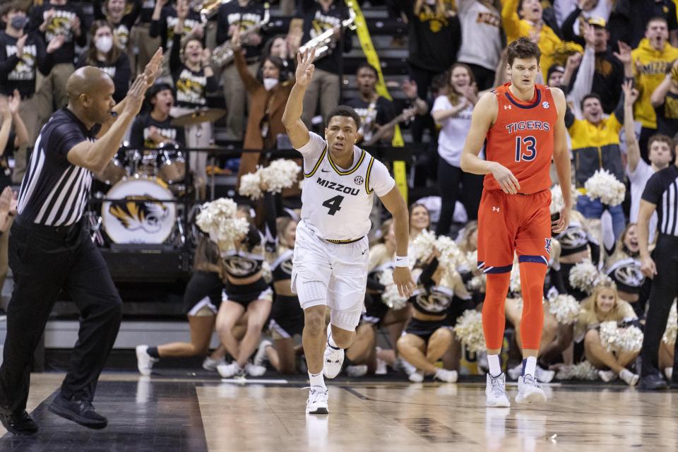 Missouri's Javon Pickett, left, celebrates a three point basket in front of Auburn's Walker Kessler, right, during the first half of an NCAA college basketball game Tuesday, Jan. 25, 2022, in Columbia, Mo. (AP Photo/L.G. Patterson)