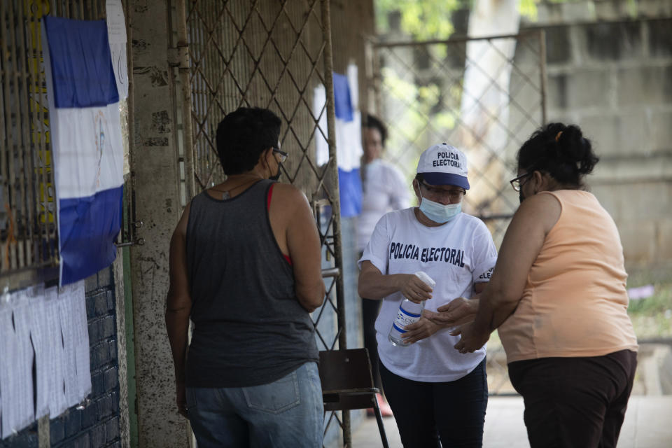 A woman has her hands disinfected prior to casting her ballot in municipal elections, in Managua, Nicaragua, Sunday, Nov. 6, 2022. After the Inter-American Commission on Human Rights expressed concern that "the minimum conditions necessary" to hold free and fair elections do not exist in Nicaragua, President Daniel Ortega's Sandinista National Liberation Front is hoping to expand on the 141 of the country's 153 municipalities that it already controls. (AP Photo)