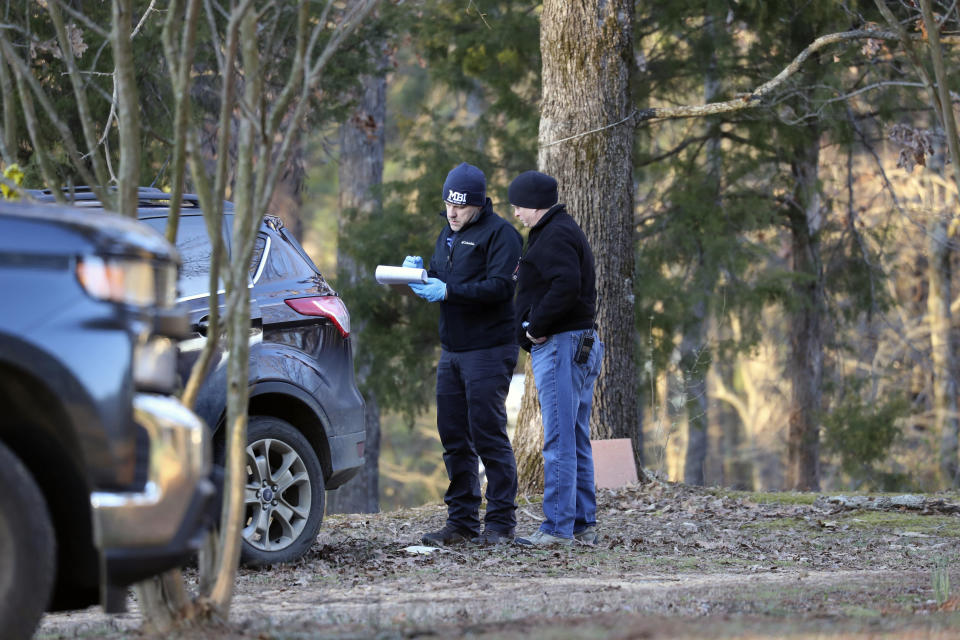 Law enforcement personnel investigate the scene of multiple shootings on Arkabutla Dam Road in Arkabutla, Miss on Friday, Feb. 17, 2023. Six people were fatally shot Friday at multiple locations in a small town in rural Mississippi near the Tennessee state line, and authorities blamed a lone suspect who was arrested and charged with murder. (AP Photo/Nikki Boertman)