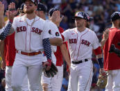 Boston Red Sox players including Trevor Story, right, congratulate each other after defeating the Tampa Bay Rays in a baseball game at Fenway Park, Monday, July 4, 2022, in Boston. (AP Photo/Mary Schwalm)