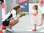 Kate receives flowers from one shy youngster.<em> [Photo: Getty]</em>