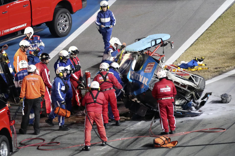 Rescue workers arrive to check on Ryan Newman after he was involved in a wreck on the last lap of the NASCAR Daytona 500 auto race at Daytona International Speedway, Monday, Feb. 17, 2020, in Daytona Beach, Fla. Sunday's race was postponed because of rain. (AP Photo/David Graham)