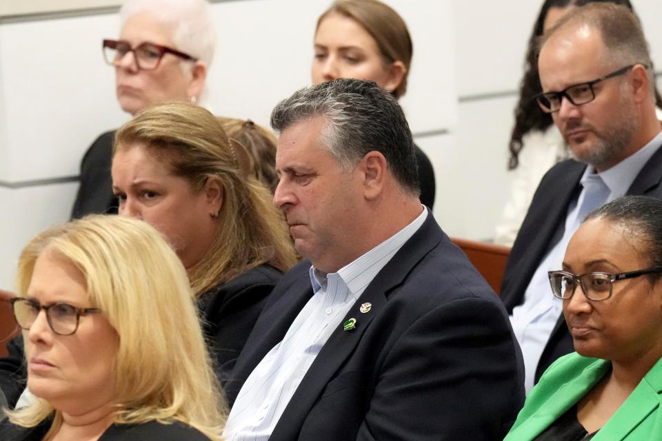 Tony Montalto, seated with his wife, Jennifer Montalto, closes his eyes as Assistant State Attorney Mike Satz details the murders of the victims including his daughter Gina during the trial (AP)