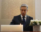 François-Philippe Champagne, Canada Minister of Foreign Affairs lights a candle in front of a plaque with the names of the victims of flight PS752, at the High Commission of Canada in London, Thursday, Jan. 16, 2020. The Foreign ministers gather in a meeting of the International Coordination and Response Group for the families of the victims of PS752 flight crashed shortly after taking off from the Iranian capital Tehran on Jan. 8, killing all 176 passengers and crew on board. (AP Photo/Frank Augstein)