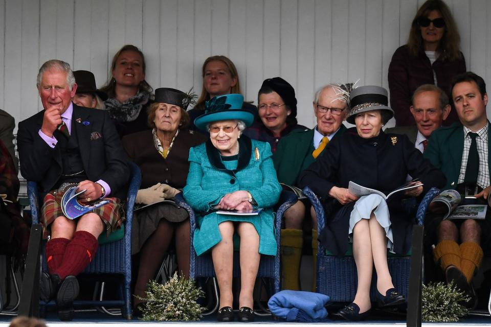 5) Queen Elizabeth, Prince Charles, and Princess Anne enjoy the Highland games.