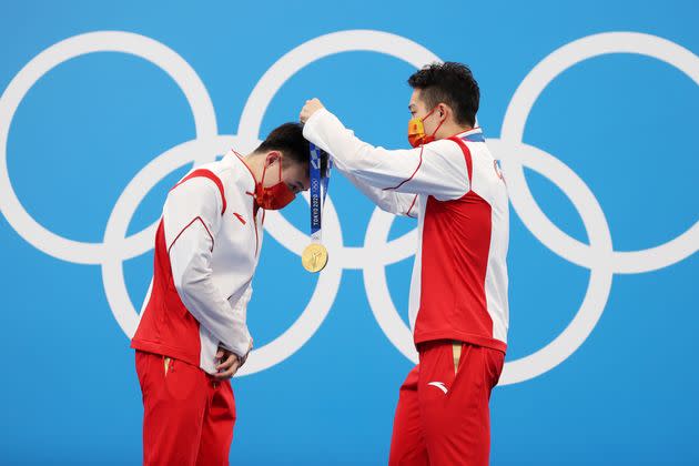 Gold medalists Zongyuan Wang and Siyi Xie of Team China during the medal ceremony for the men's synchronized 3 meter springboard diving final on July 28. (Photo: Maddie Meyer via Getty Images)