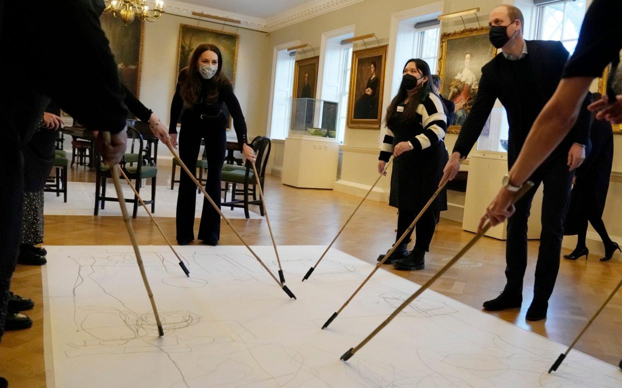 While at the Foundling Museum the royal couple took part in a task that involved drawing on a canvas while looking only at the people in front of them without looking at what they were drawing on the floor - Alastair Grant/AP