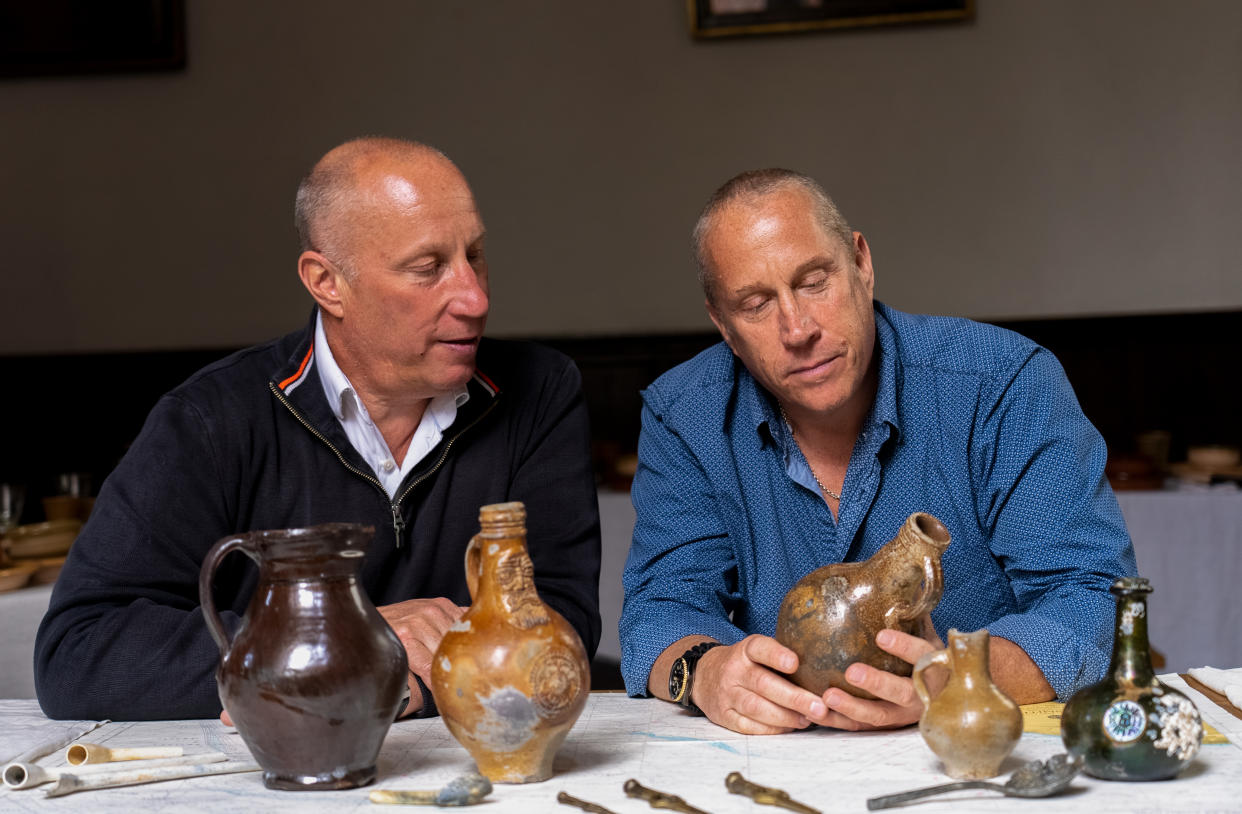 Brothers Julian and Lincoln Barnwell with some of the artefacts from the HMS Gloucester. (UEA/ PA)