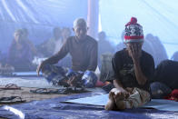 <p>Villagers sit in a temporary shelter in Bali, Indonesia, Sept. 23, 2017. Indonesian authorities raised the alert level for the Mount Agung volcano on the tourist island to the highest level, and more than 11,000 villagers left their homes around the mountain, officials said Friday. (AP Photo/Firdia Lisnawati) </p>