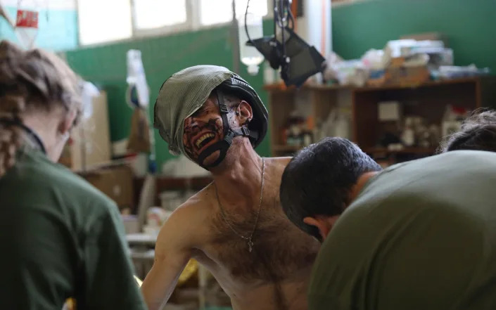 Medics help an injured Ukrainian serviceman in Zaporizhzhia