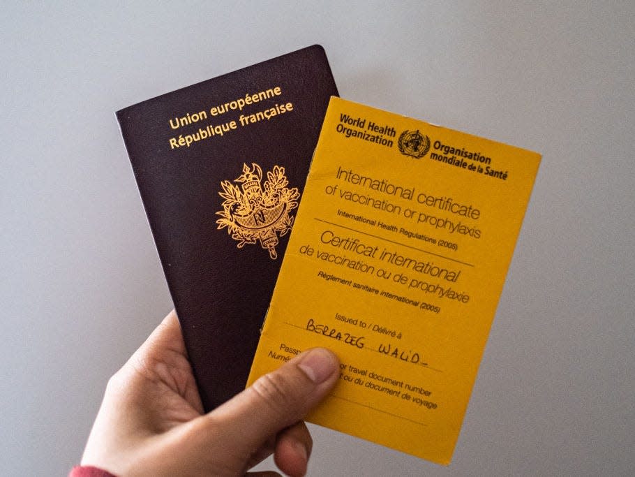 Immunization passport / vaccination card from the World Health Organisation and a French Passport.