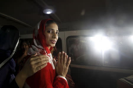 Geeta holds her palms together as she looks out of a van while leaving for an airport to depart for New Delhi, outside the Edhi Foundation in Karachi, Pakistan, October 26, 2015. REUTERS/Akhtar Soomro