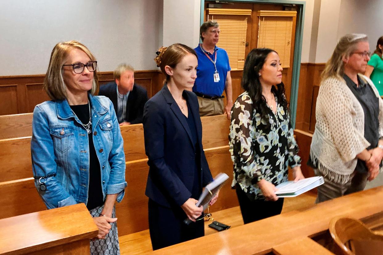 Sheena Greitens, center, the ex-wife of former Missouri Gov. and U.S. Senate candidate Eric Greitens, rises at the beginning of a court session in a child custody case on Thursday, June 23, 2022, at the Boone County Courthouse in Columbia.