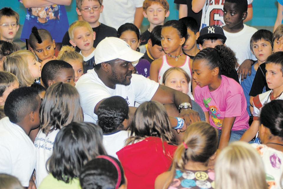 A former Bartlesville High multi-sport standout mingles with youth at the Bartlesville Boys & Girls Club several weeks after the New England Patriots drafted him in 2011.