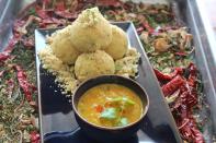 <p>A favorite dal preparation across Marwadi & Rajasthani homes. Mixed lentils (dal) is served with thick, round wheat flour bread & often a dessert -Churma. To make dal, boil 10gms each of Toor dal, Black Urad dal, Chana dal & split Moong dal along with salt, reserve. Heat 1 tsp ghee in a kadhai, add cumin seeds, whole garam masala, one chopped onion & cook until it is light brown. Add one chopped tomato & red chili powder, salt & turmeric powder to taste. Mix well. Add boiled dal & cook for sometime. Add chopped fresh coriander. To make batti- Make dough from 150 gms wheat flour & 100 gms ghee & enough water. Make 3 to 4 dough balls of equal proportions. Cook in the oven at 160 degrees. Arrange the baatis on a serving plate, break each baati into two pieces and pour melted ghee on the baatis. Serve with dal. Image & recipe- Maharaja Jankidas Vaishnav, Sofitel Mumbai BKC </p>