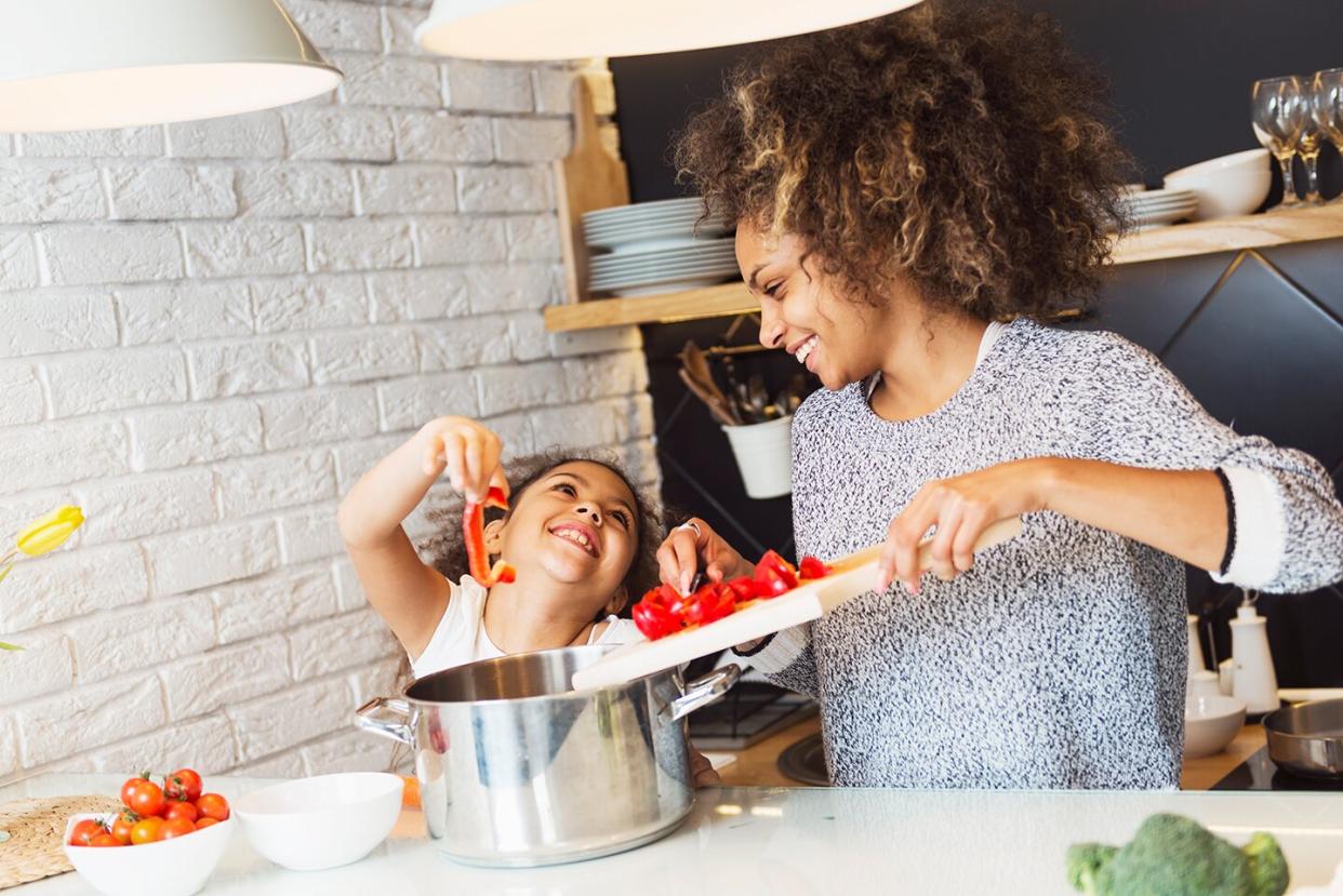 Mom and her daughter cooking in the kitchen