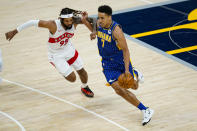 Indiana Pacers guard Malcolm Brogdon (7) drives on Toronto Raptors forward DeAndre' Bembry (95) during the first half of an NBA basketball game in Indianapolis, Sunday, Jan. 24, 2021. (AP Photo/Michael Conroy)