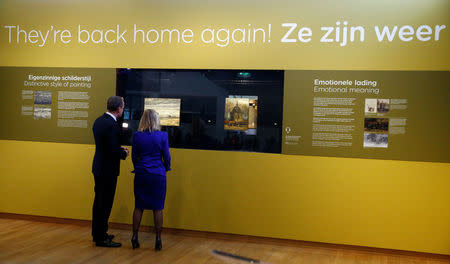 Museum director Axel Ruger and Dutch Minister of Education, Culture and Science Jet Bussemaker look at two recovered paintings by Vincent van Gogh, which were stolen from the museum in 2002, at the van Gogh Museum in Amsterdam, Netherlands March 21, 2017. REUTERS/Michael Kooren