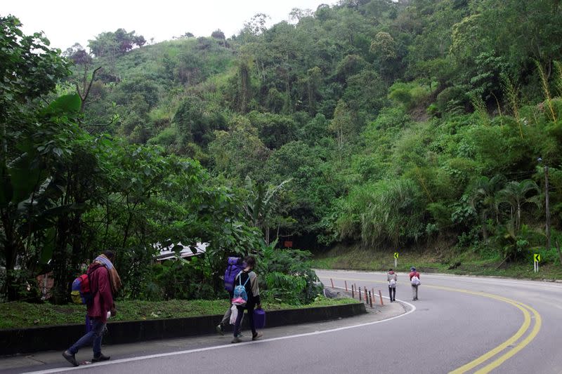 Venezuelan migrants wearing face masks walk on Colombian roads in Bucaramanga