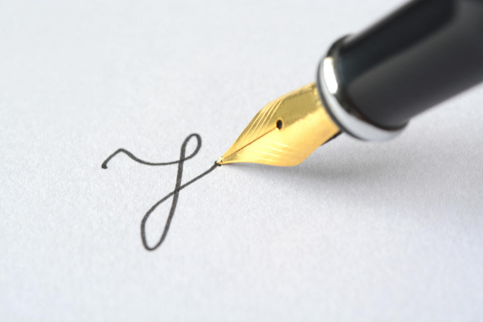 A pen writing in cursive