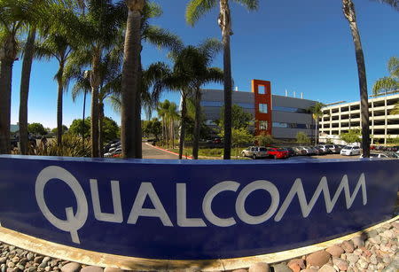 A Qualcomm sign is pictured in front of one of its many buildings in San Diego, California in this November 5, 2014 file photo. REUTERS/Mike Blake/Files BUSINESS