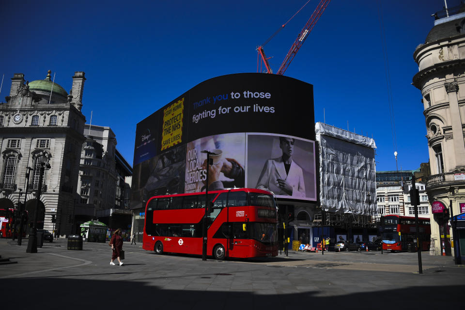 Messages in support of the key workers are seen on the advertising facade of Piccadilly Circus, due to the Coronavirus outbreak, in London, Tuesday, April 14, 2020. The new coronavirus causes mild or moderate symptoms for most people, but for some, especially older adults and people with existing health problems, it can cause more severe illness or death.(AP Photo/Alberto Pezzali)