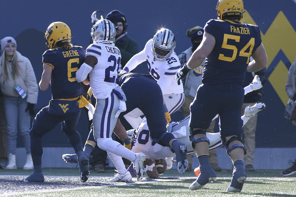 Kansas State safety Cincere Mason jumps for a touchdown after an interception against West Virginia during the first half of an NCAA college football game in Morgantown, W.Va., Saturday, Nov. 19, 2022. (AP Photo/Kathleen Batten)