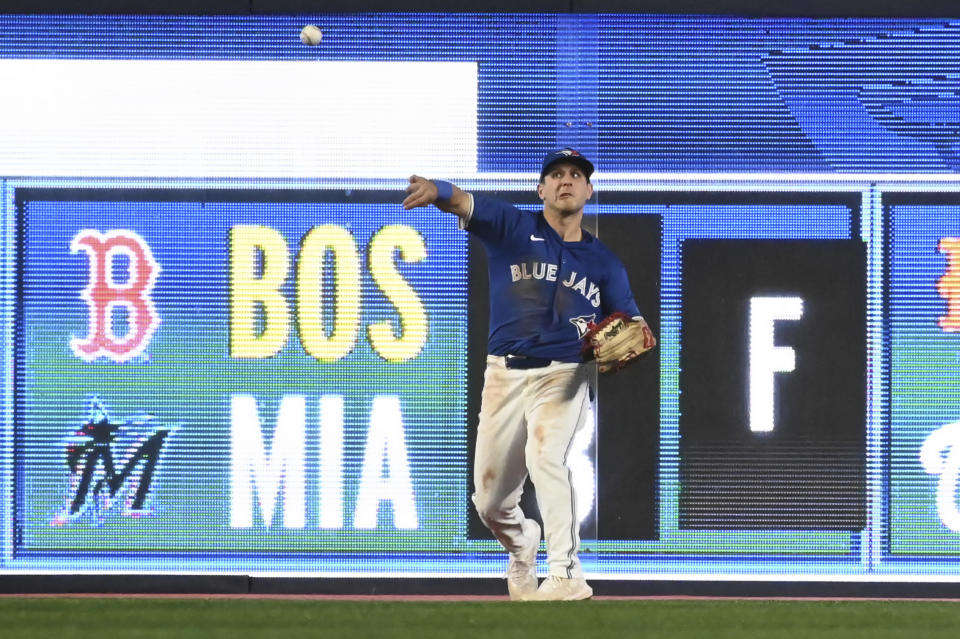 Toronto Blue Jays outfielder Daulton Varsho (25) plays a double hit off the wall by Houston Astros' Jeremy Pena (3) during the ninth inning of a baseball game, Tuesday, July 2, 2024, in Toronto. (Jon Blacker/The Canadian Press via AP)