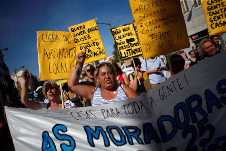 People shout slogans during a demonstration against evictions and rising of rent prices in central Lisbon, Portugal September 22, 2018. REUTERS/Pedro Nunes