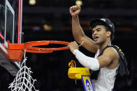 Kansas guard Remy Martin cuts the net after their win against North Carolina in a college basketball game at the finals of the Men's Final Four NCAA tournament, Monday, April 4, 2022, in New Orleans. (AP Photo/Brynn Anderson)