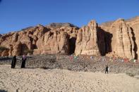 Visitors are seen at the Madain Saleh antiquities site, in Al-Ula