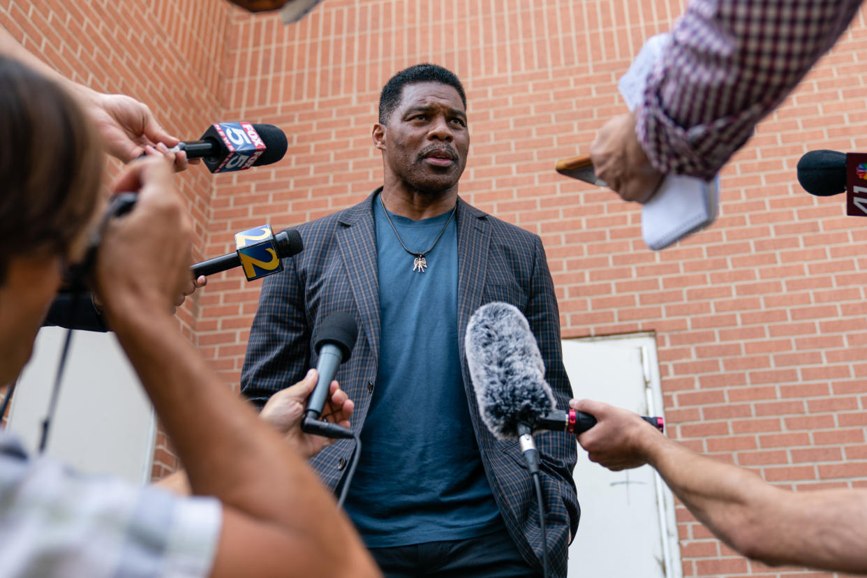 Herschel Walker talks to the media.