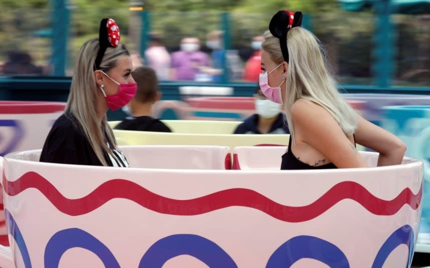 Masks did not ruin the Disney fun for these two visitors - REUTERS/CHARLES PLATIAU