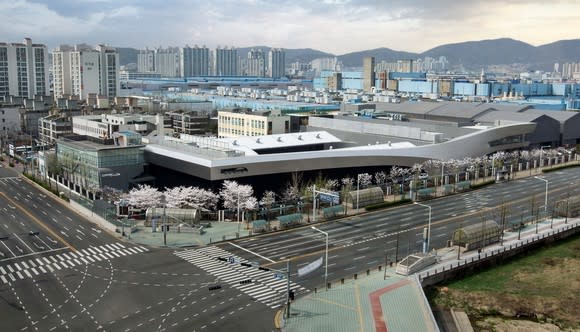 An aerial photo of a large, low building in an urban area.