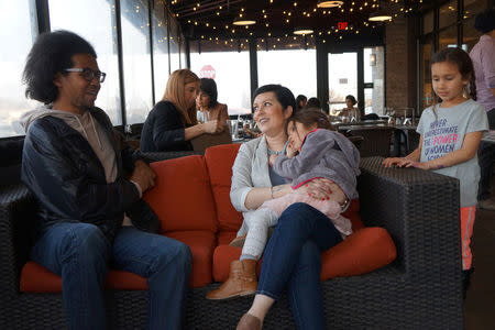 Democrat Nicole Bedi, a candidate for the Michigan House of Representatives, who seeking the party's nomination in a competitive district that Democrats need to wrest back from Republicans in an effort to flip a critical statehouse, is joined by her daughters at a campaign event in West Bloomfield, Michigan, U.S., March 28, 2018. REUTERS/Letitia Stein/Files