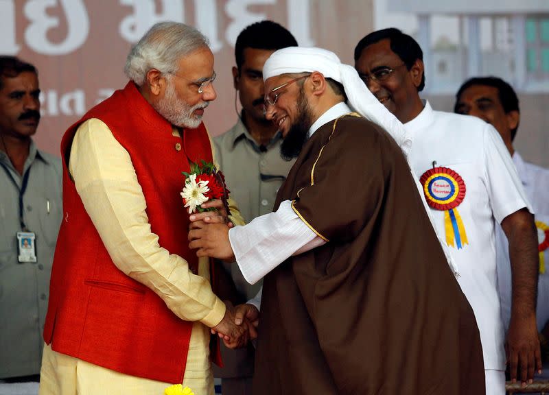 FILE PHOTO: Narendra Modi receives flowers from a Muslim cleric after inauguration of a hospital in Balasinore