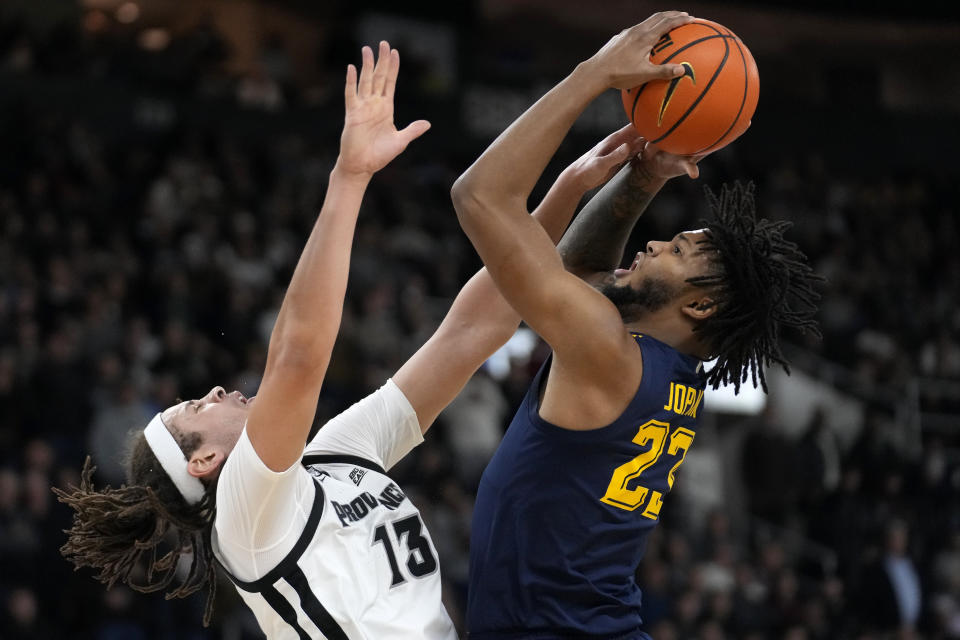 Marquette forward David Joplin (23) shoots as Providence forward Josh Oduro (13) defends during the second half of an NCAA college basketball game Tuesday, Dec. 19, 2023, in Providence, R.I. (AP Photo/Steven Senne)