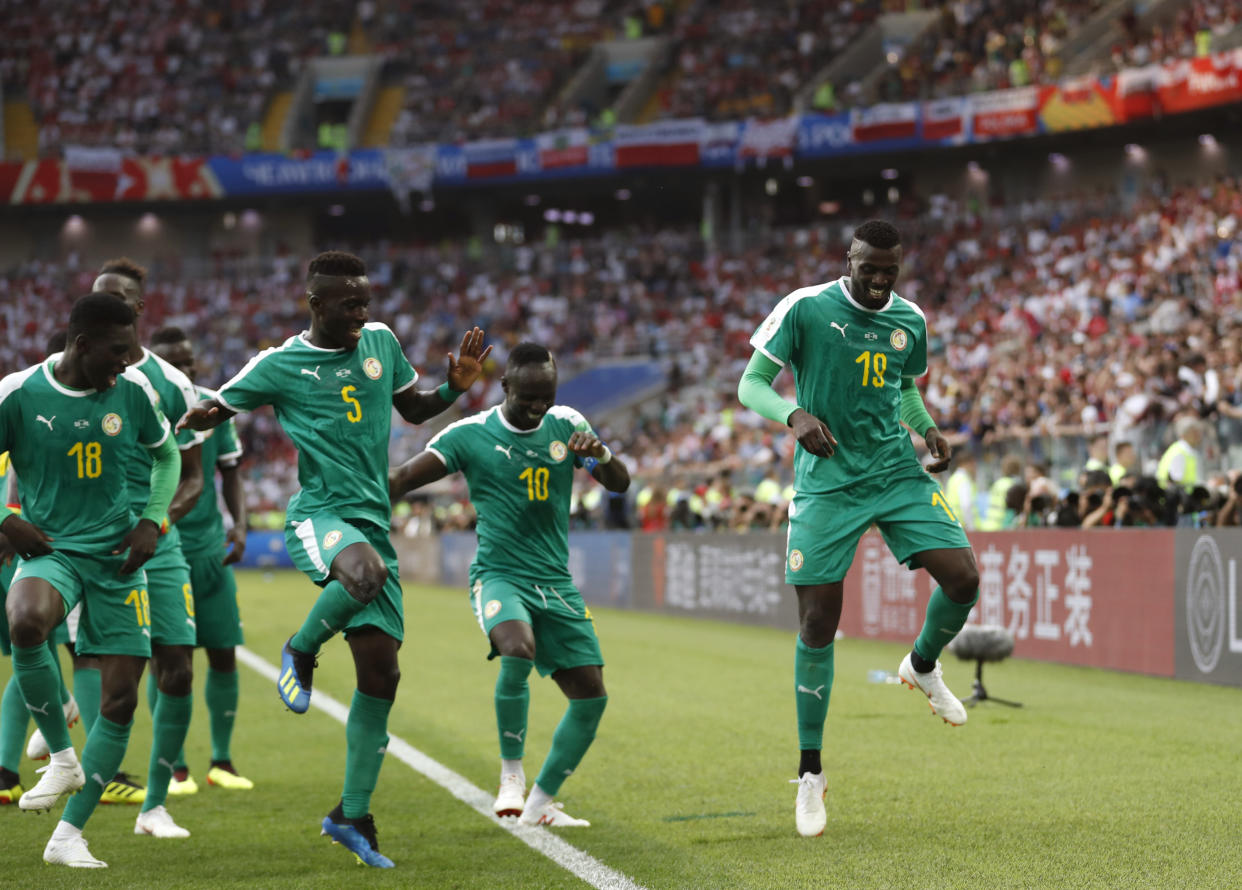 Senegal’s M’baye Niang, right, dances in celebration of his controversial goal against Poland at the 2018 World Cup. (AP)