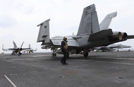 A U.S. F/A-18E Super Hornet is seen parked on the flight deck of USS George Washington during military manoeuvre exercises, known as Keen Sword 15, between the U.S. and Japanese Self-Defense Force in the sea south of Japan, November 18, 2014. REUTERS/Tim Kelly