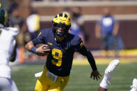 Michigan quarterback J.J. McCarthy rushes during the second half of an NCAA college football game against Colorado State, Saturday, Sept. 3, 2022, in Ann Arbor, Mich. (AP Photo/Carlos Osorio)