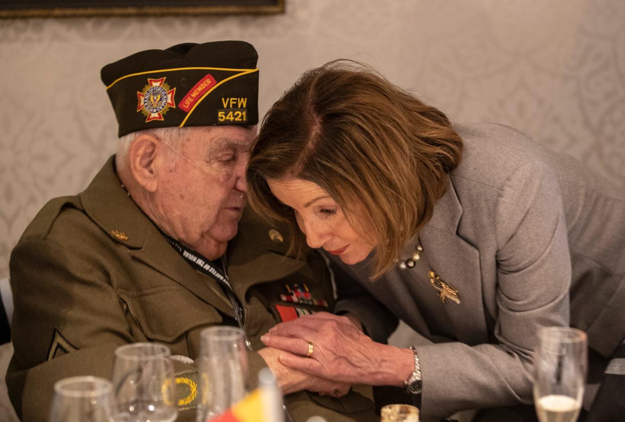 Speaker of the House Nancy Pelosi leans in close to George Merz to better hear what he is saying while attending a luncheon Dec. 14, 2019, for the 75th anniversary of the Battle of the Bulge.