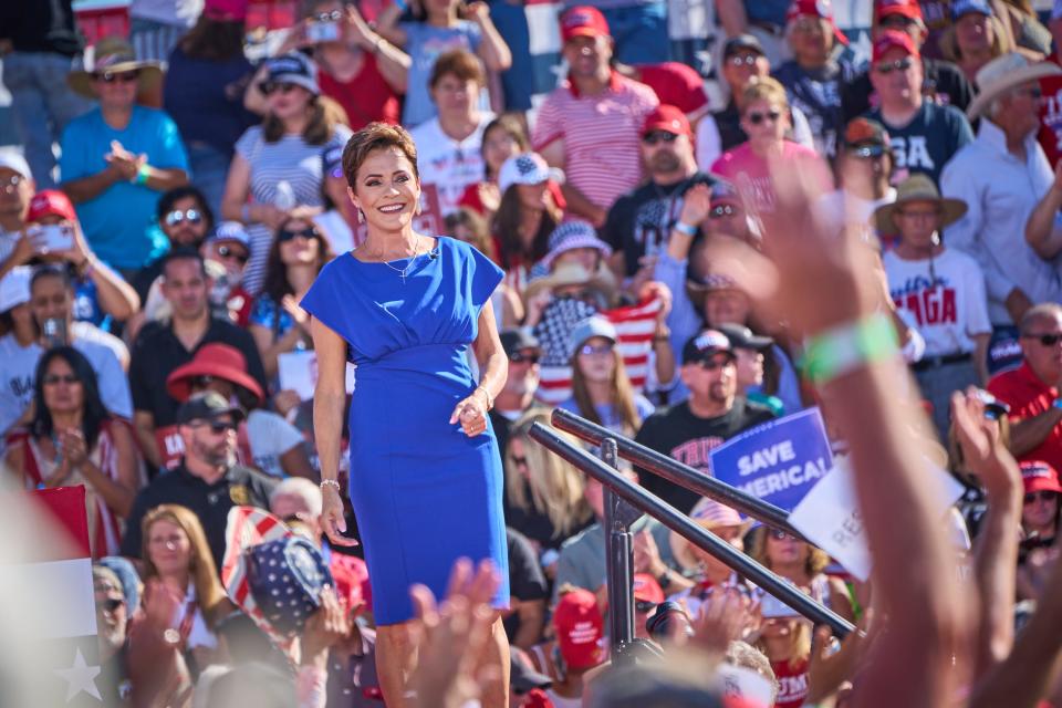 Gubernatorial candidate Kari Lake leaves the stage after delivering remarks during former President Donald Trump's rally at Legacy Sports Park in Mesa on Sunday, Oct. 9, 2022.