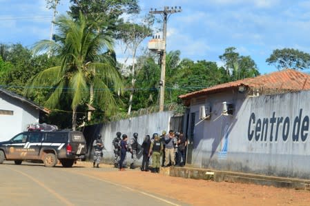 Policemen and soldiers are seen in front of a prison after a riot, in the city of Altamira